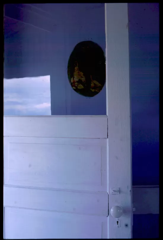 White door open onto blue wall