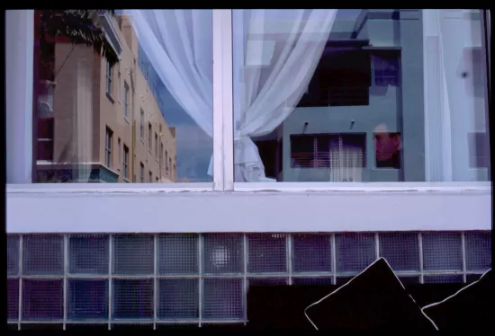 Reflections in a window above a tile wall