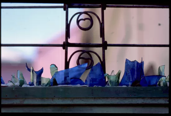 Broken colored glass bottles on ledge