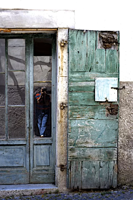 Cork reflected in the glass of an old door